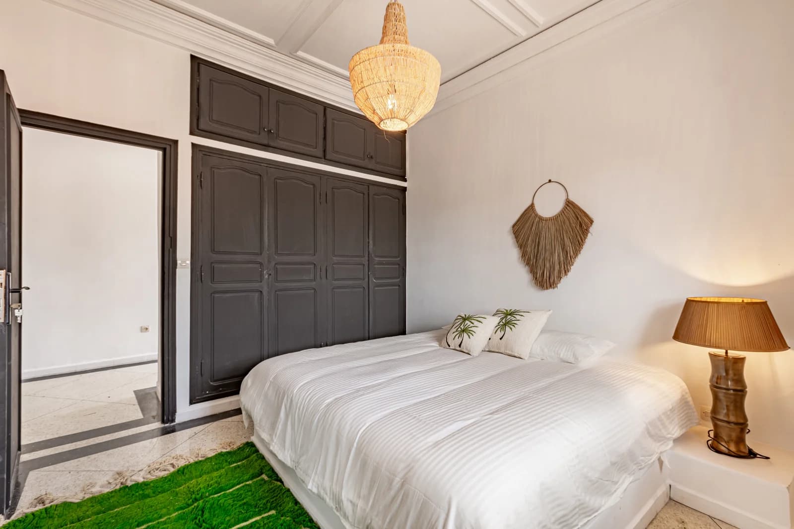 Twin-style bedroom with crystal pendant and panelled wardrobe wall