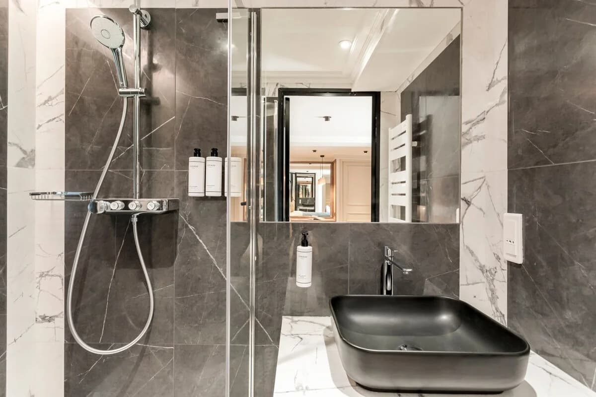 Charcoal marble bathroom with matte black basin and glass shower