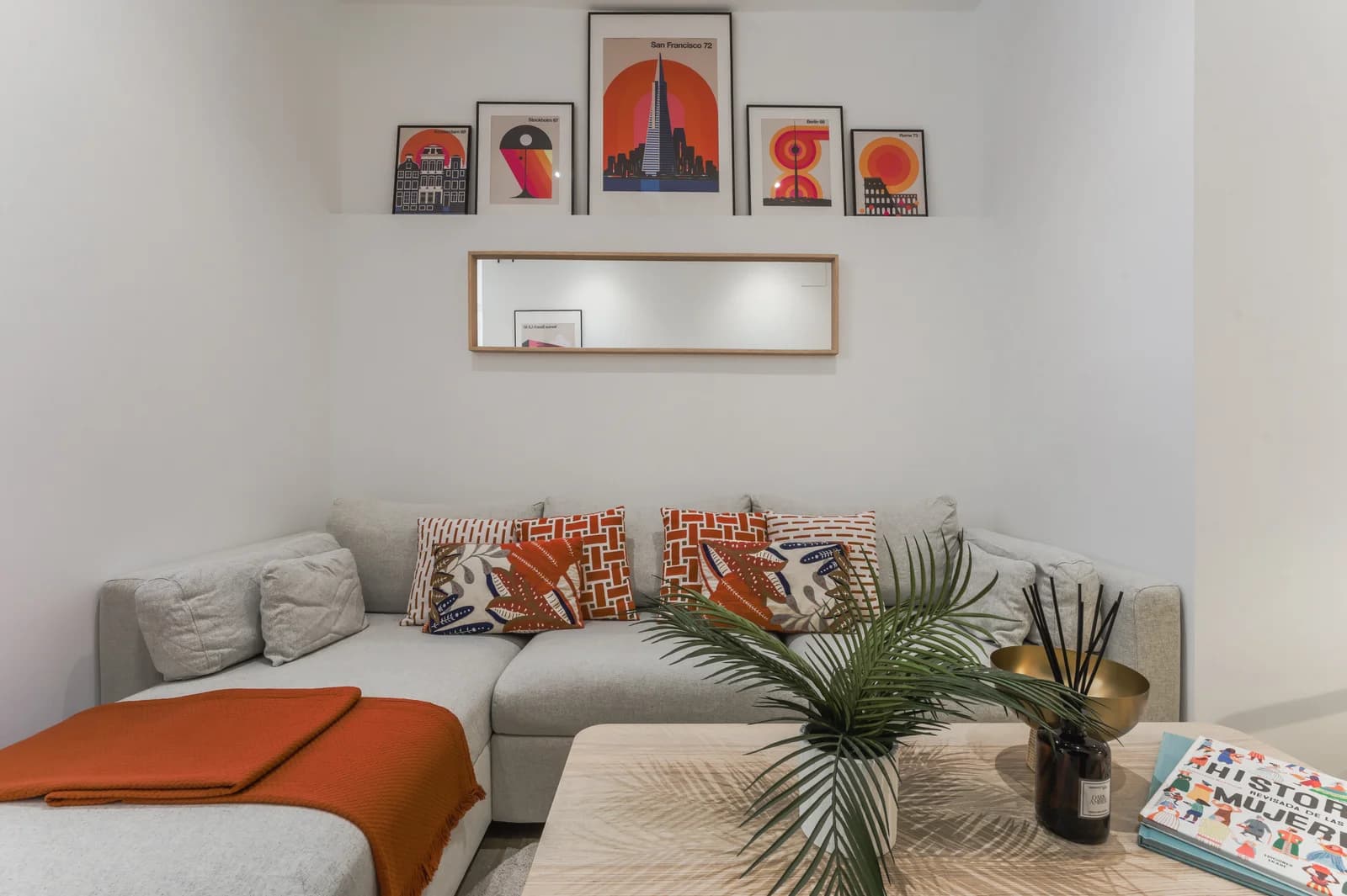 Cosy reading nook with palm and graphic art arrangement