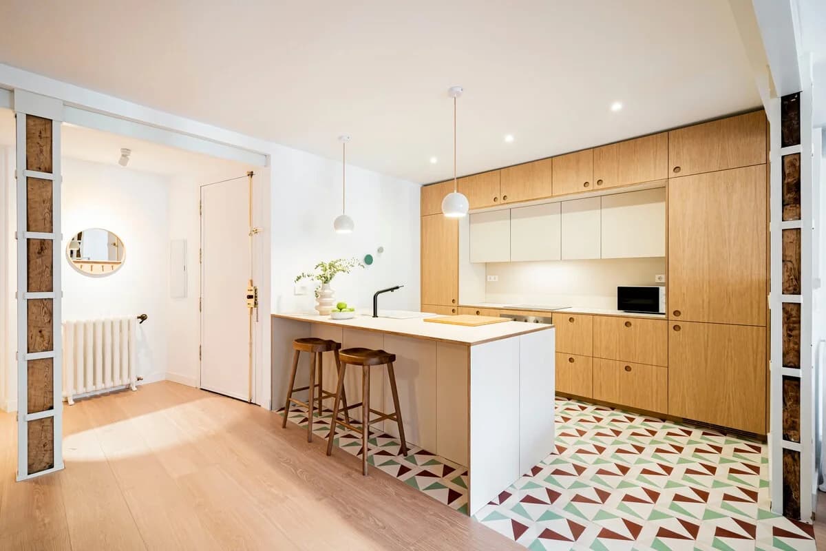 Bright entry kitchen with geometric tile floor and reclaimed beam columns