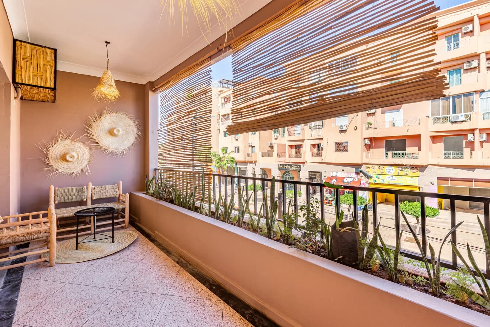 Shaded balcony with reed canopy, palm-frond mirrors and planters