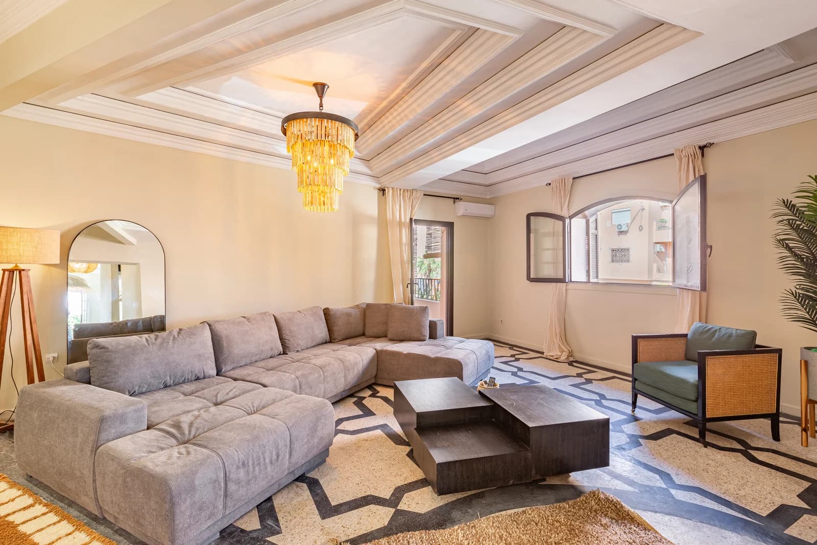 Velvet sectional sofa with arched window light and graphic floor pattern