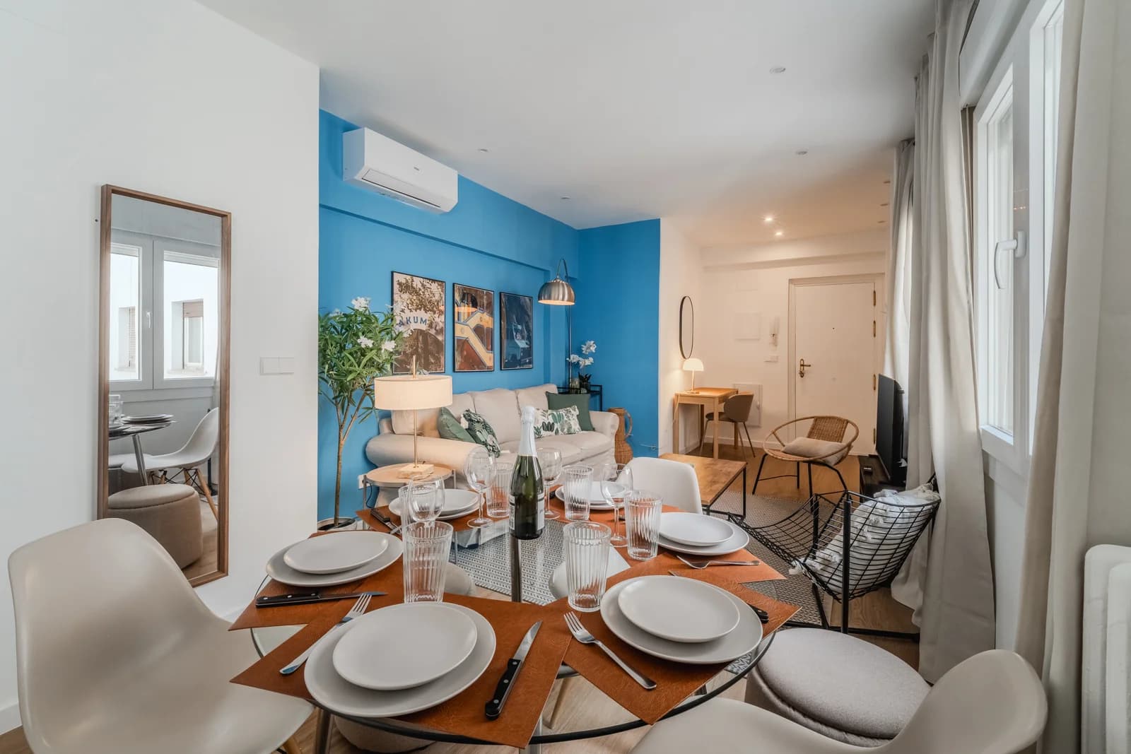 Dining-led view across living room with floor mirror reflection