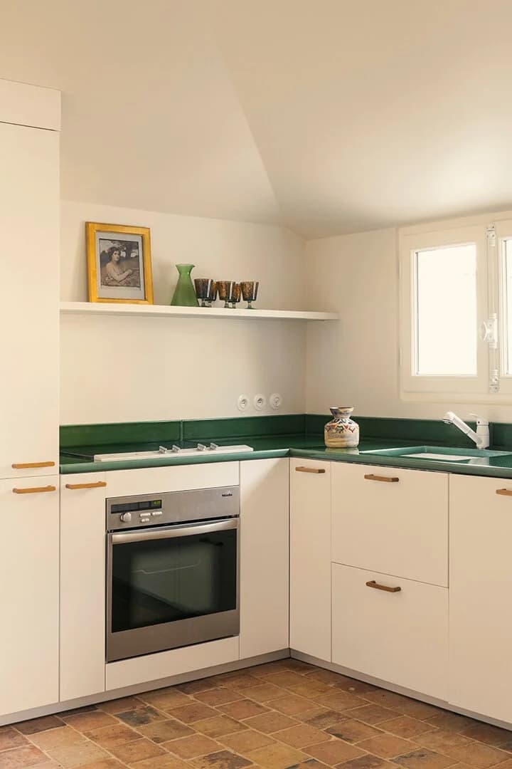 Vintage Provencal kitchen with green tile counter and Miele oven