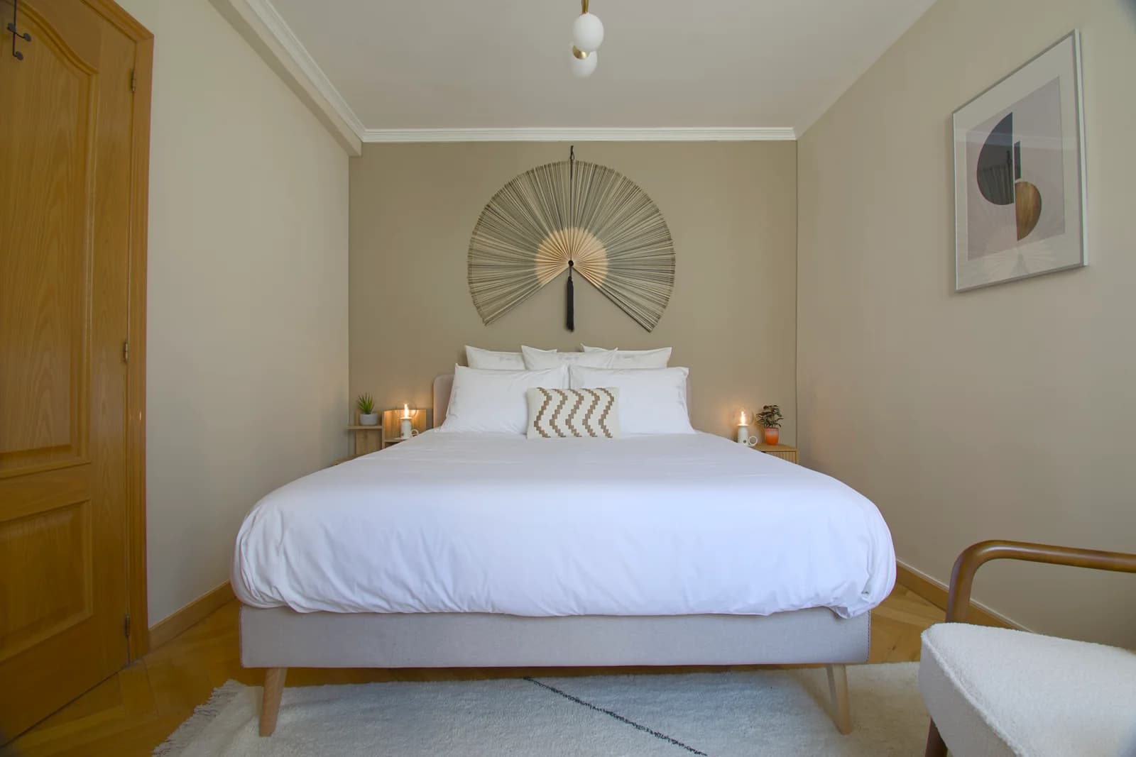 Serene primary bedroom with sculptural fan headboard and king bed
