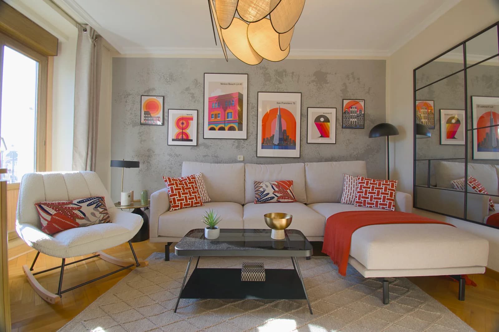 Wide living room with rattan pendant, gallery wall, and warm sectional