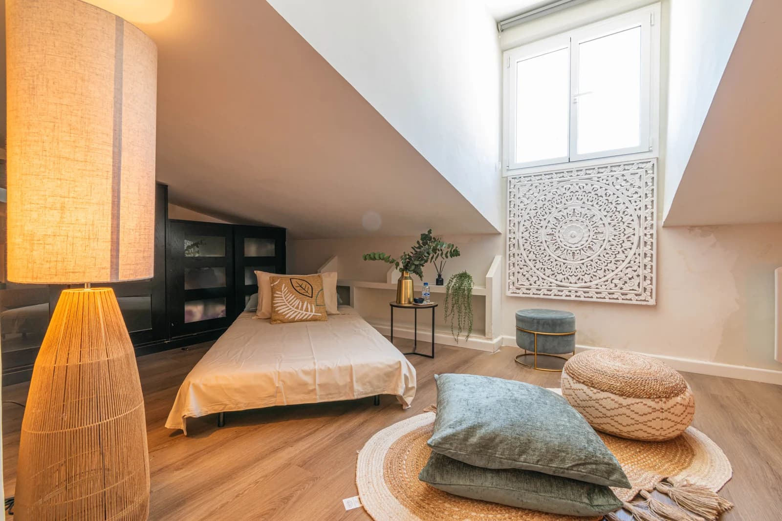 Second bedroom under eaves with carved wood mandala panel