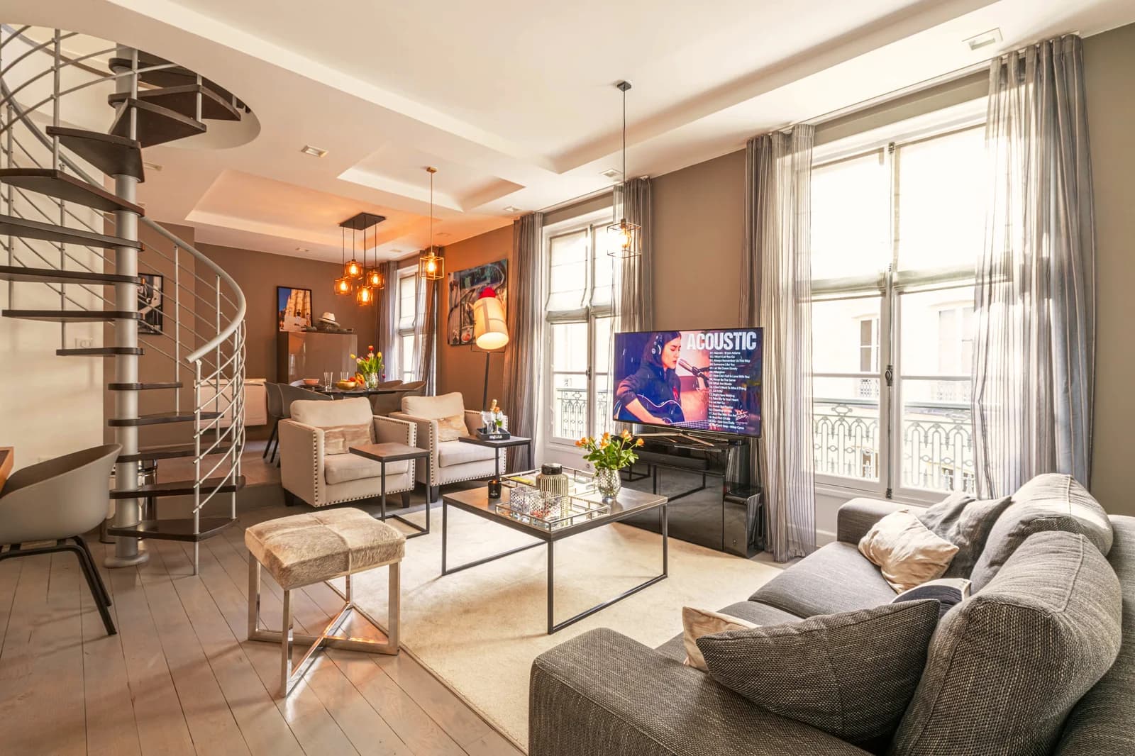 Parisian salon with spiral staircase and tall French windows