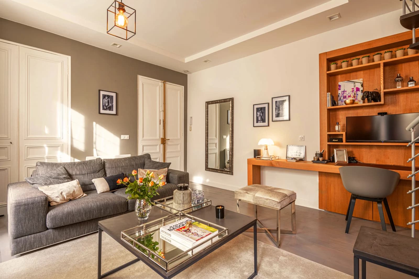 Living area with built-in bar shelving and classical mouldings