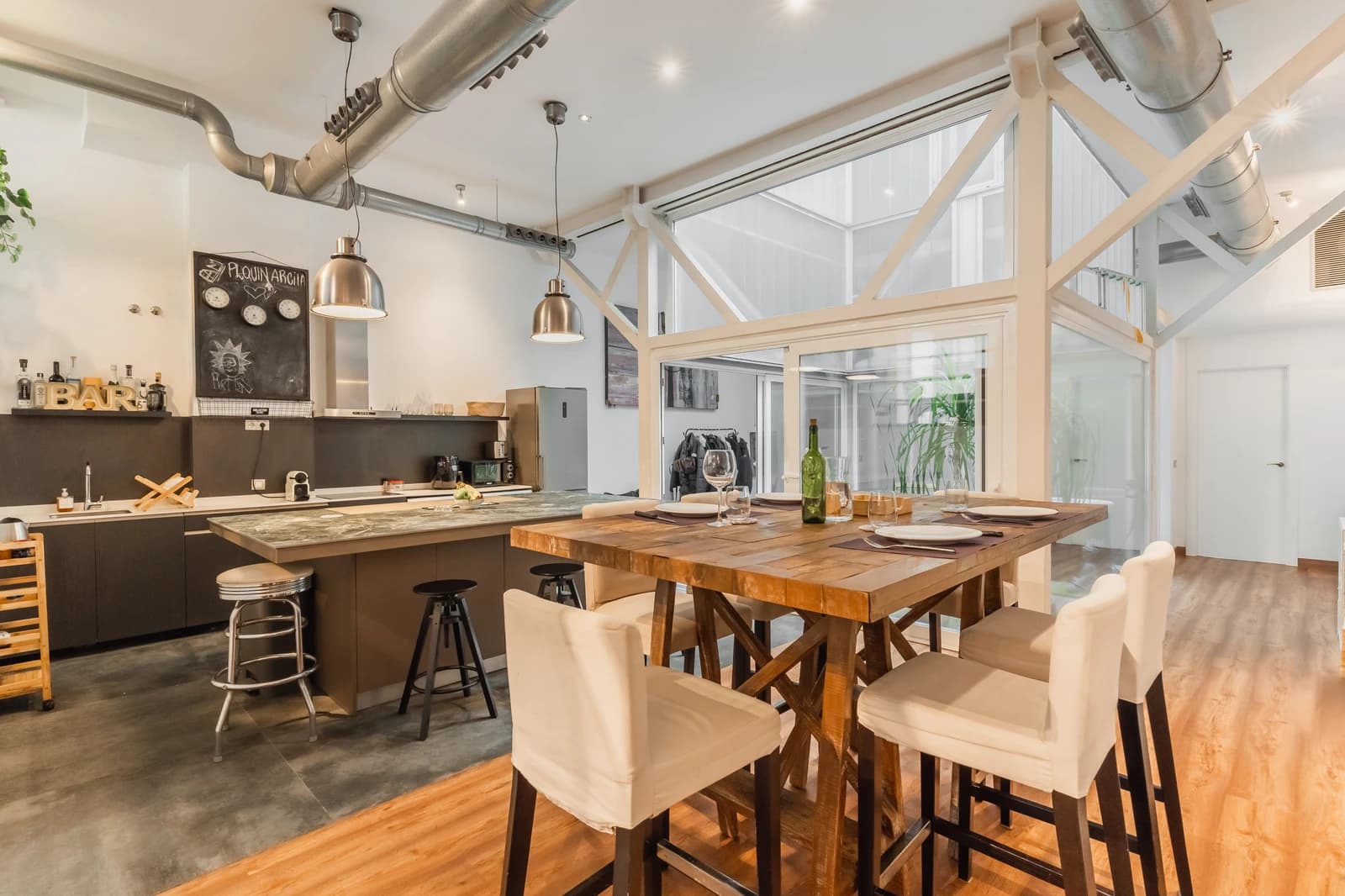 Loft overview from mezzanine showing kitchen, dining, and atrium