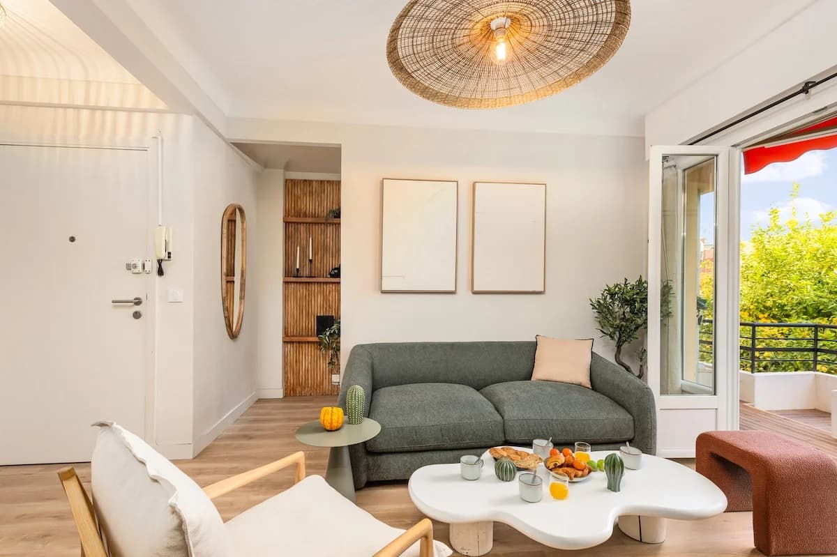 Living room with rattan pendant and balcony bathed in afternoon light
