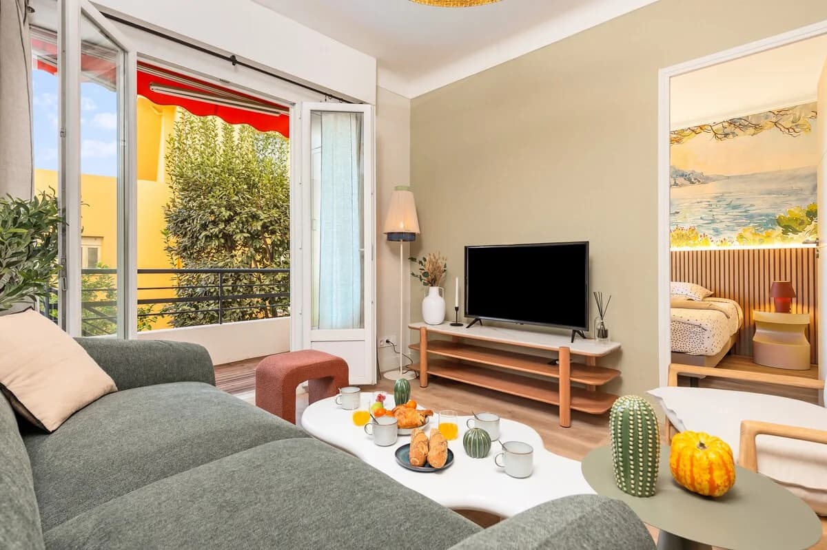 Living room opening to balcony with breakfast styled on cloud table