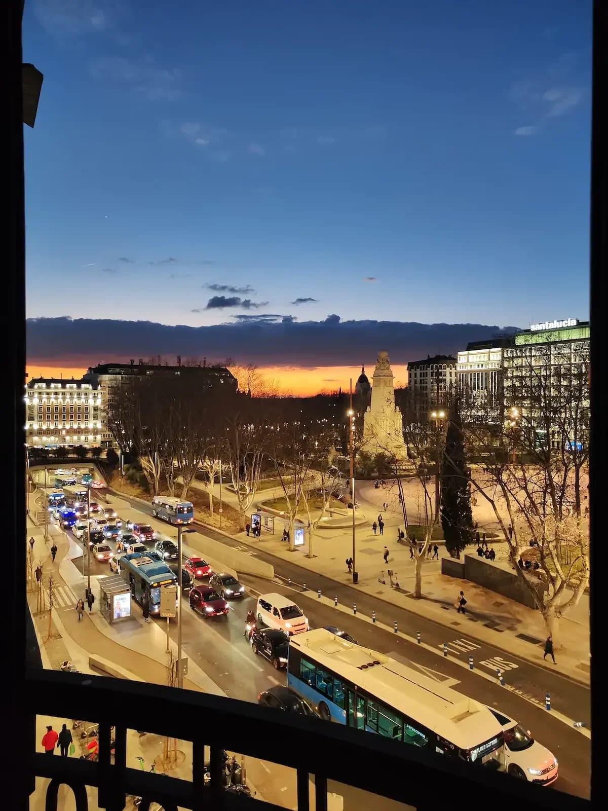 Plaza de España at twilight glowing with city lights and traffic
