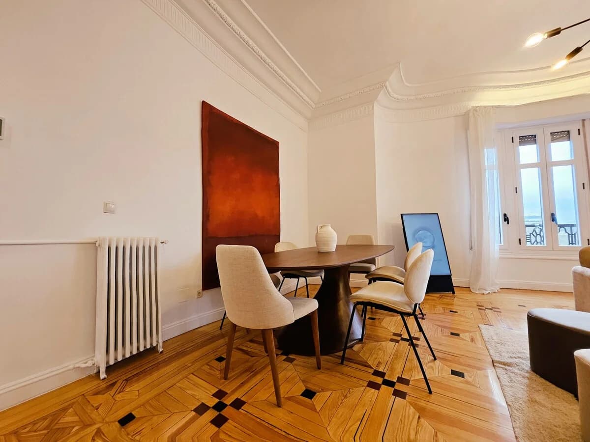 Dining nook with Rothko-inspired canvas and herringbone parquet