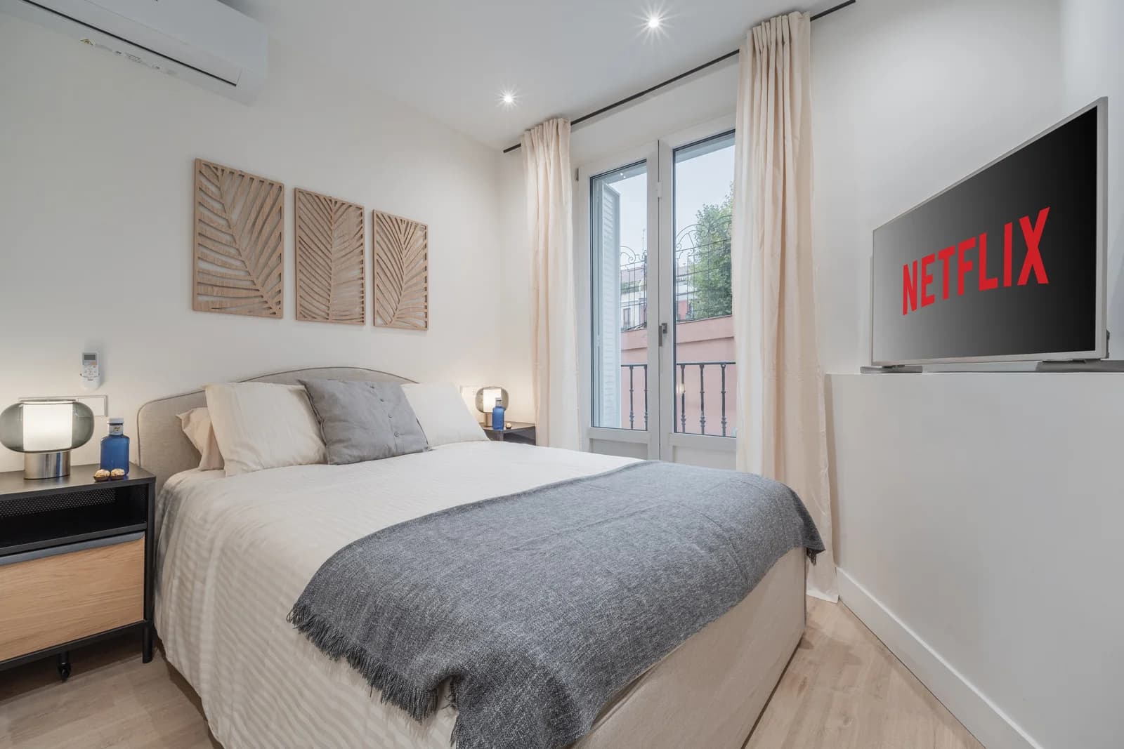 Tranquil bedroom with woven palm panels and balcony