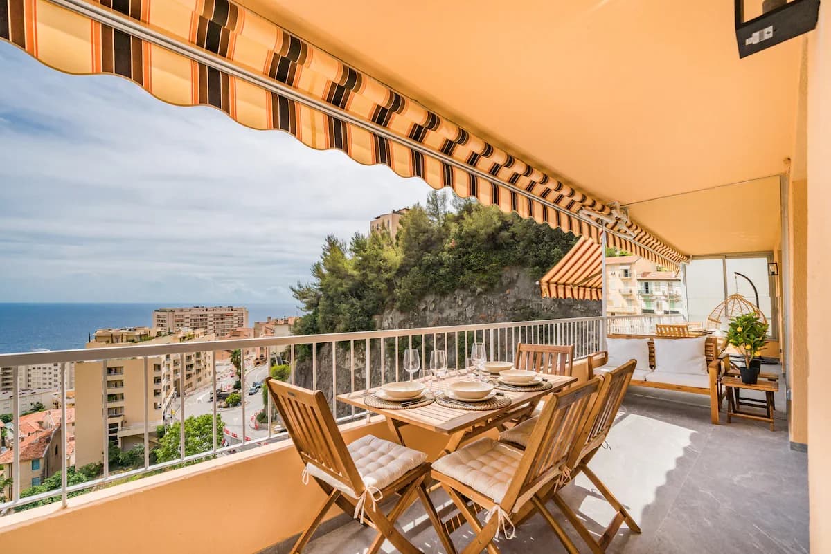 Balcony dining for six set against the Mediterranean coastline