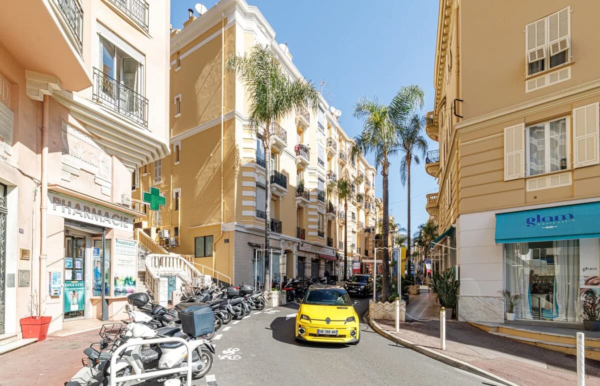 Belle-époque street view with palm trees and pastel building facades