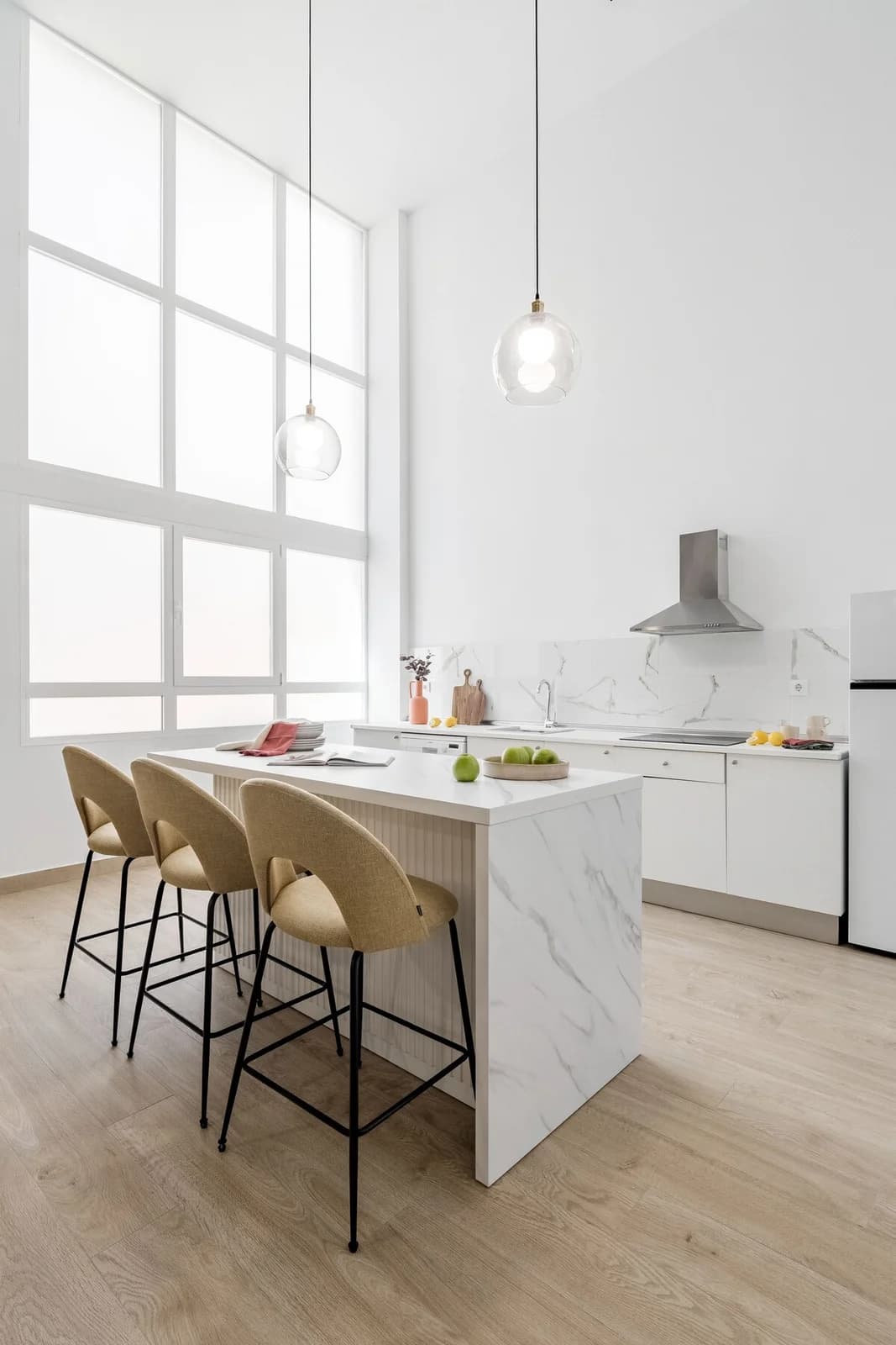 Bright kitchen with gridded factory windows and breakfast bar stools