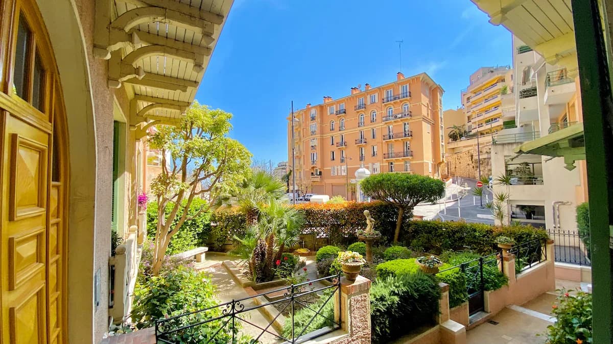View from entrance onto landscaped courtyard with palms and hedges