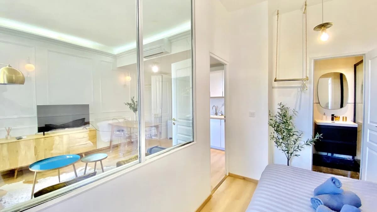 Through-view from bedroom to lounge, kitchenette and ensuite via interior glazing