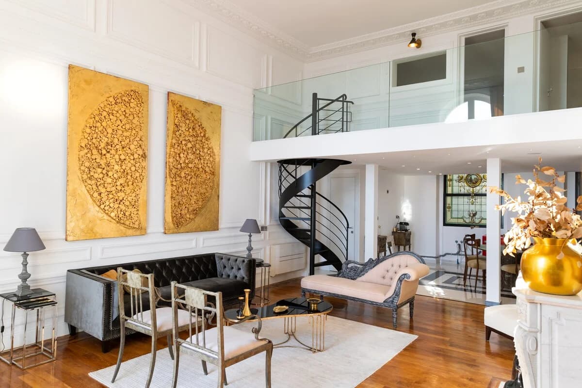 Lounge with chesterfield sofa, gold leaf canvases and wraparound mezzanine