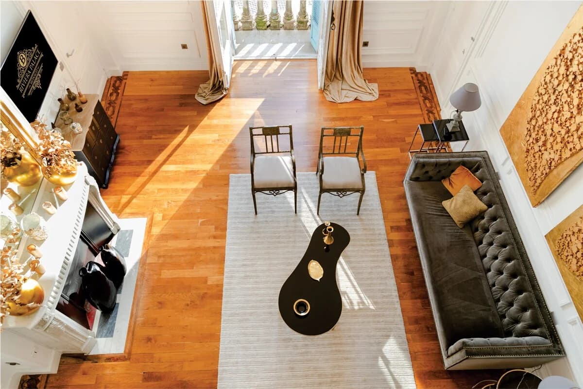 Aerial view of velvet sofa, kidney coffee table and balcony beyond
