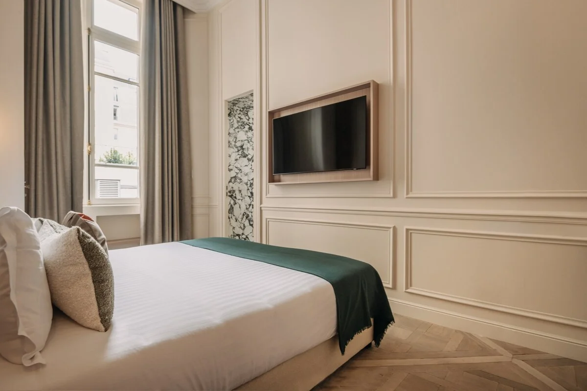 Second bedroom with classic mouldings and slim marble accent niche