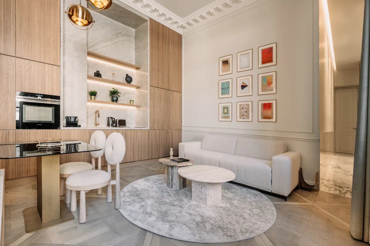 Wide Parisian living room with art wall, boucle sofa and travertine tables