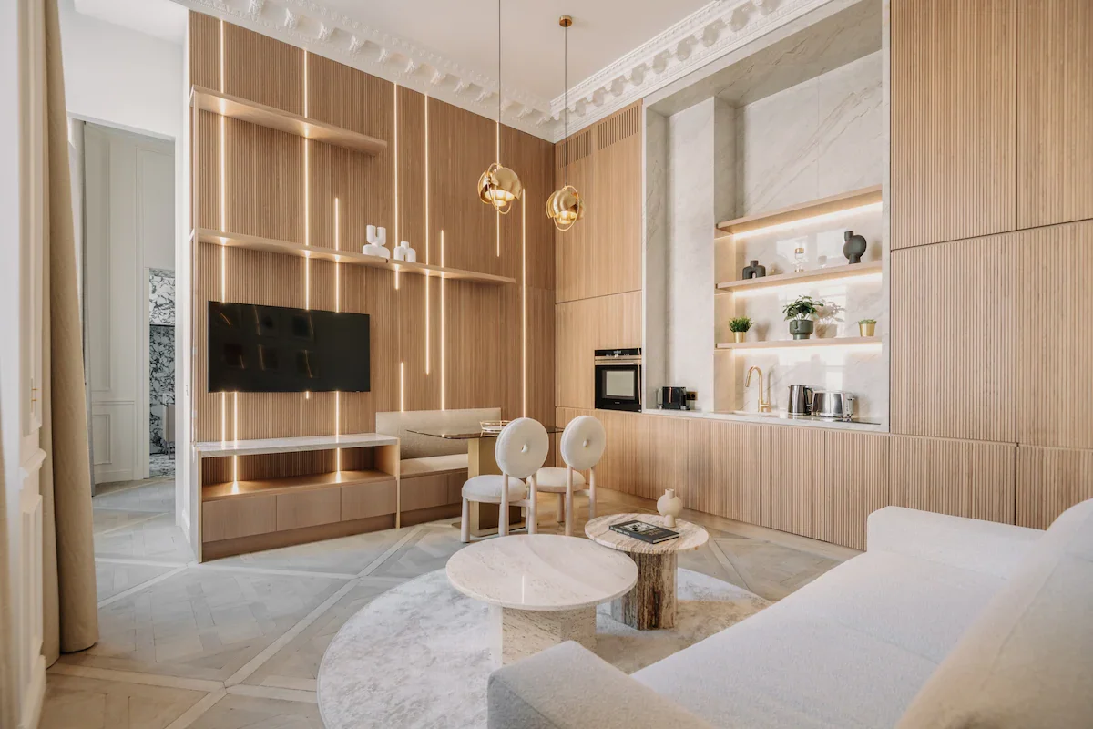 Living room from sofa angle showcasing media wall and herringbone parquet