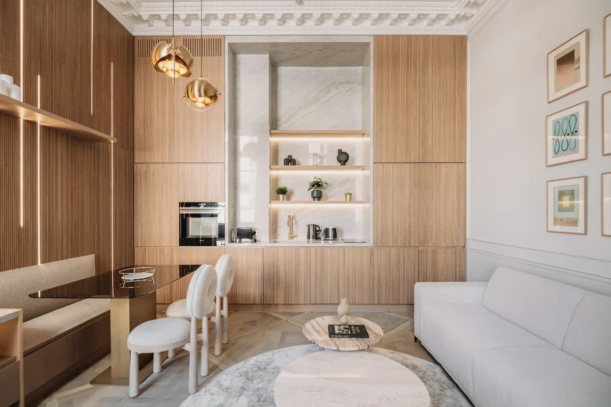 Open living kitchen with backlit marble shelves and dining banquette