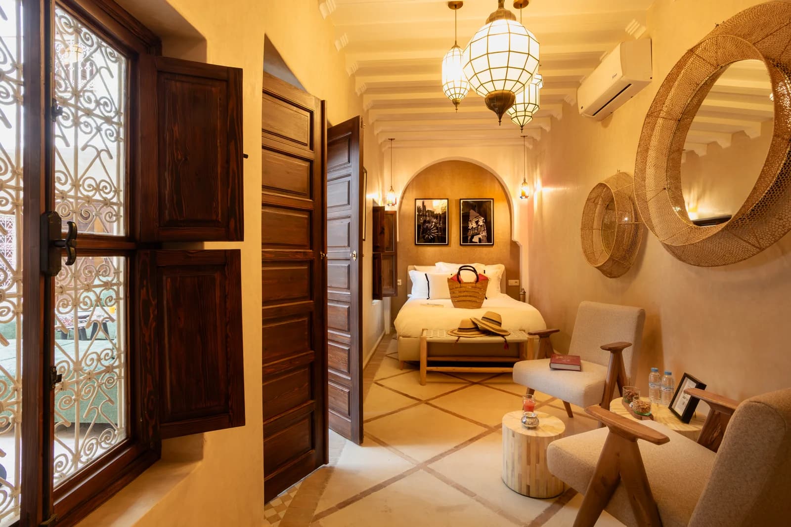 Bedroom approach through carved doors with iron-grilled window light