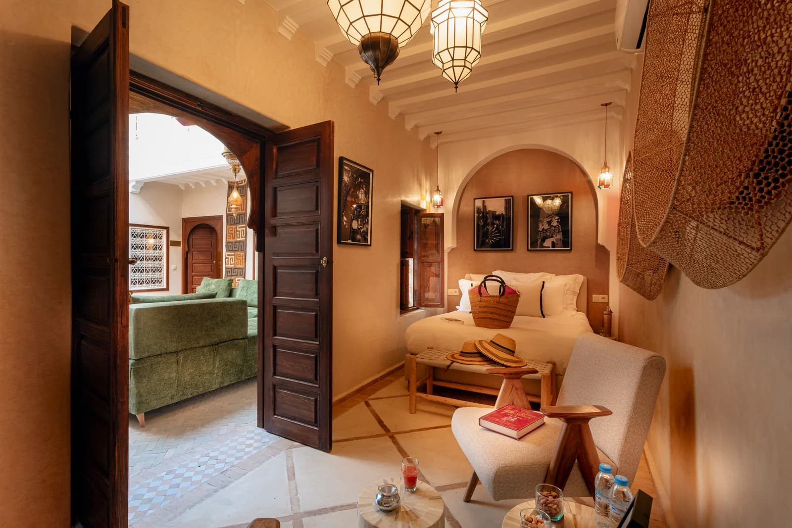 Bedroom with arched headboard alcove and pendant lanterns over double doors