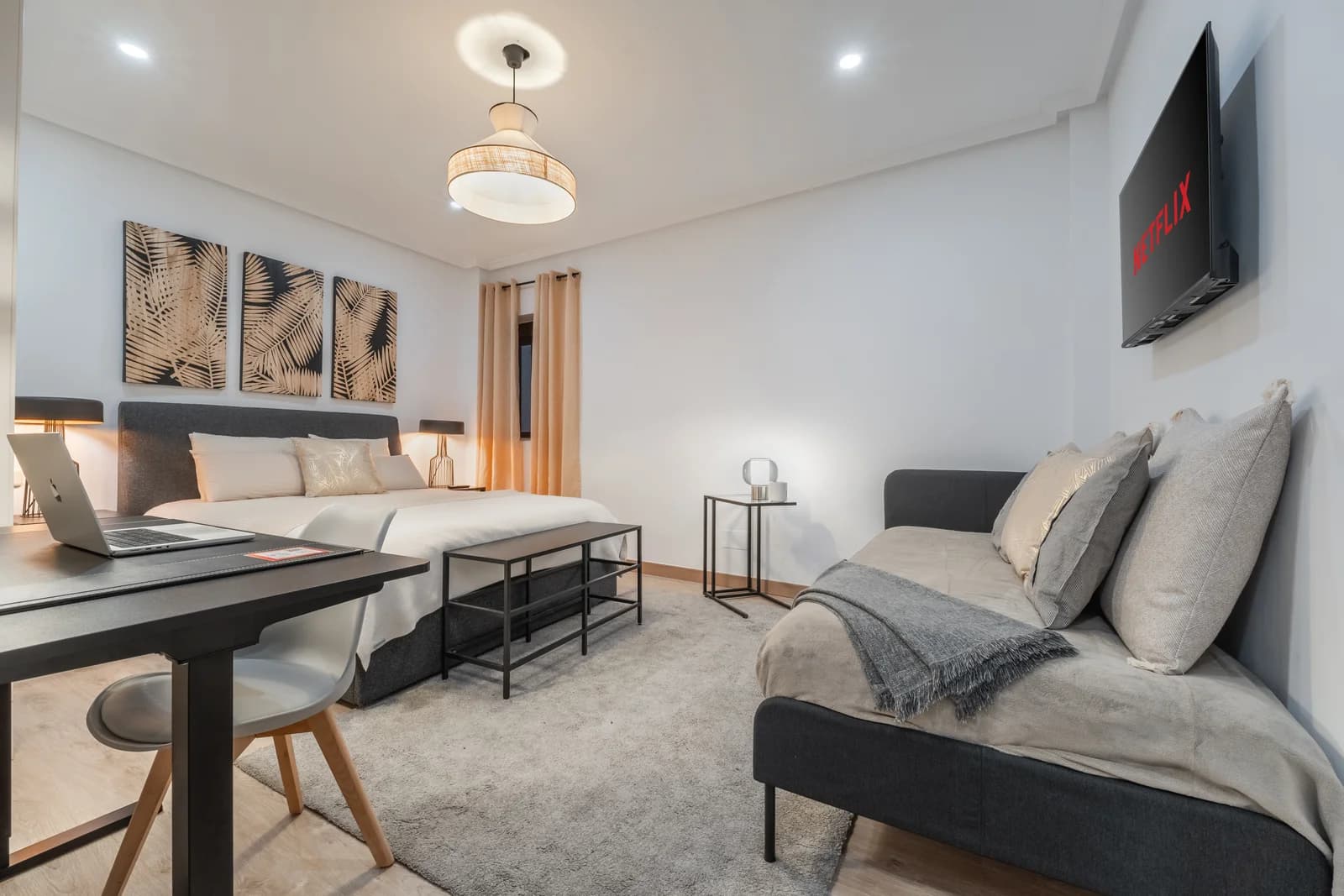 Bedroom workspace with desk, daybed and palm-print triptych