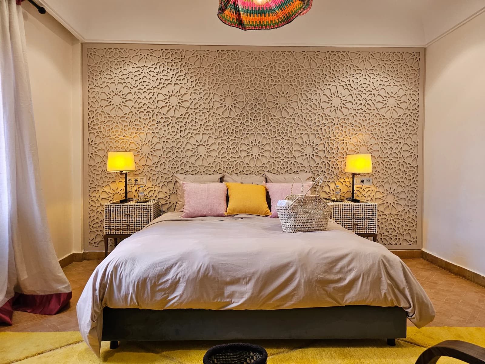 Warm-toned bedroom with carved feature wall and yellow rug accent