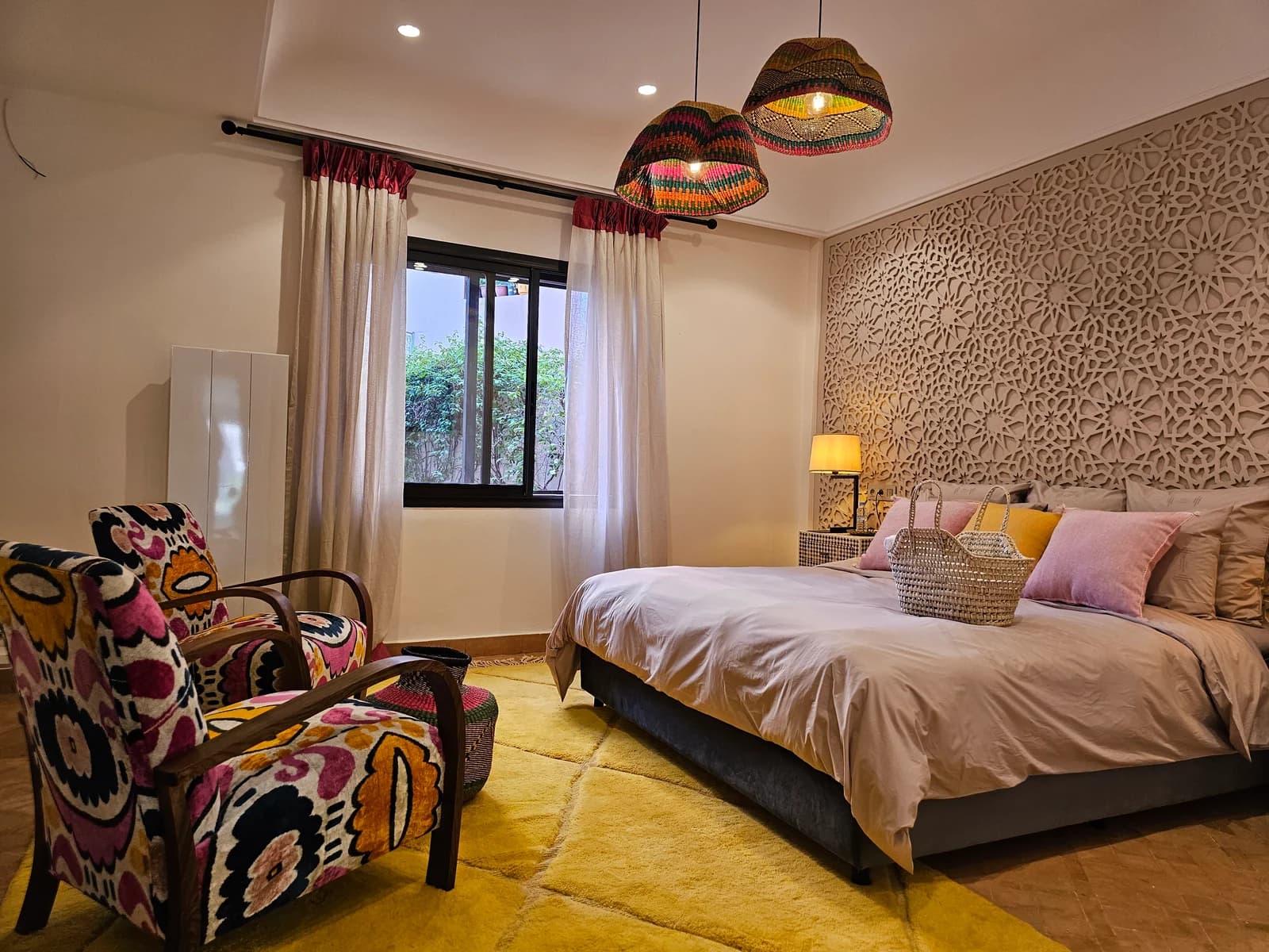 Bedroom with patterned reading chair, knit pendants and patterned wall