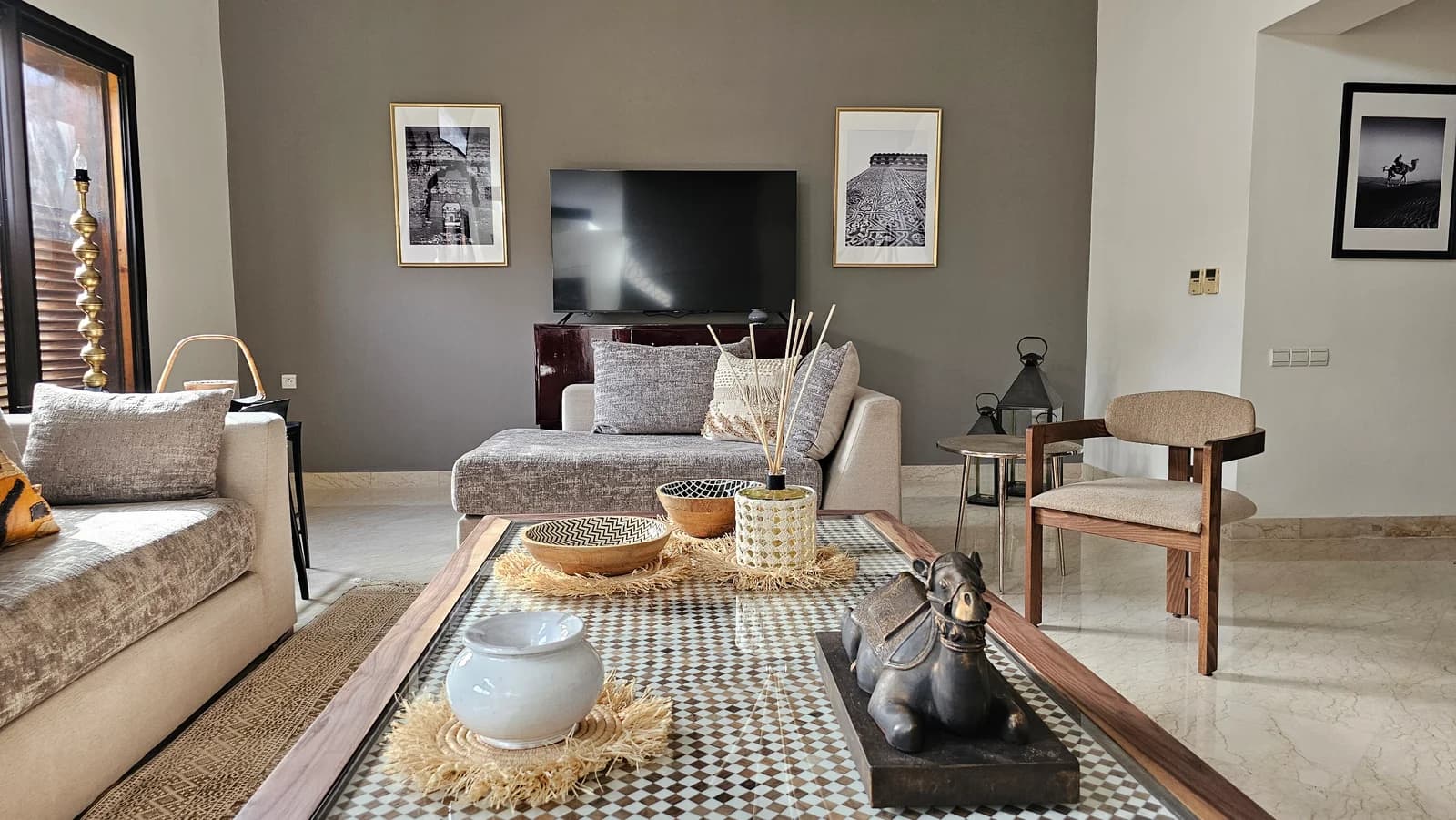 Living seating arrangement with checkered coffee table and curated artwork