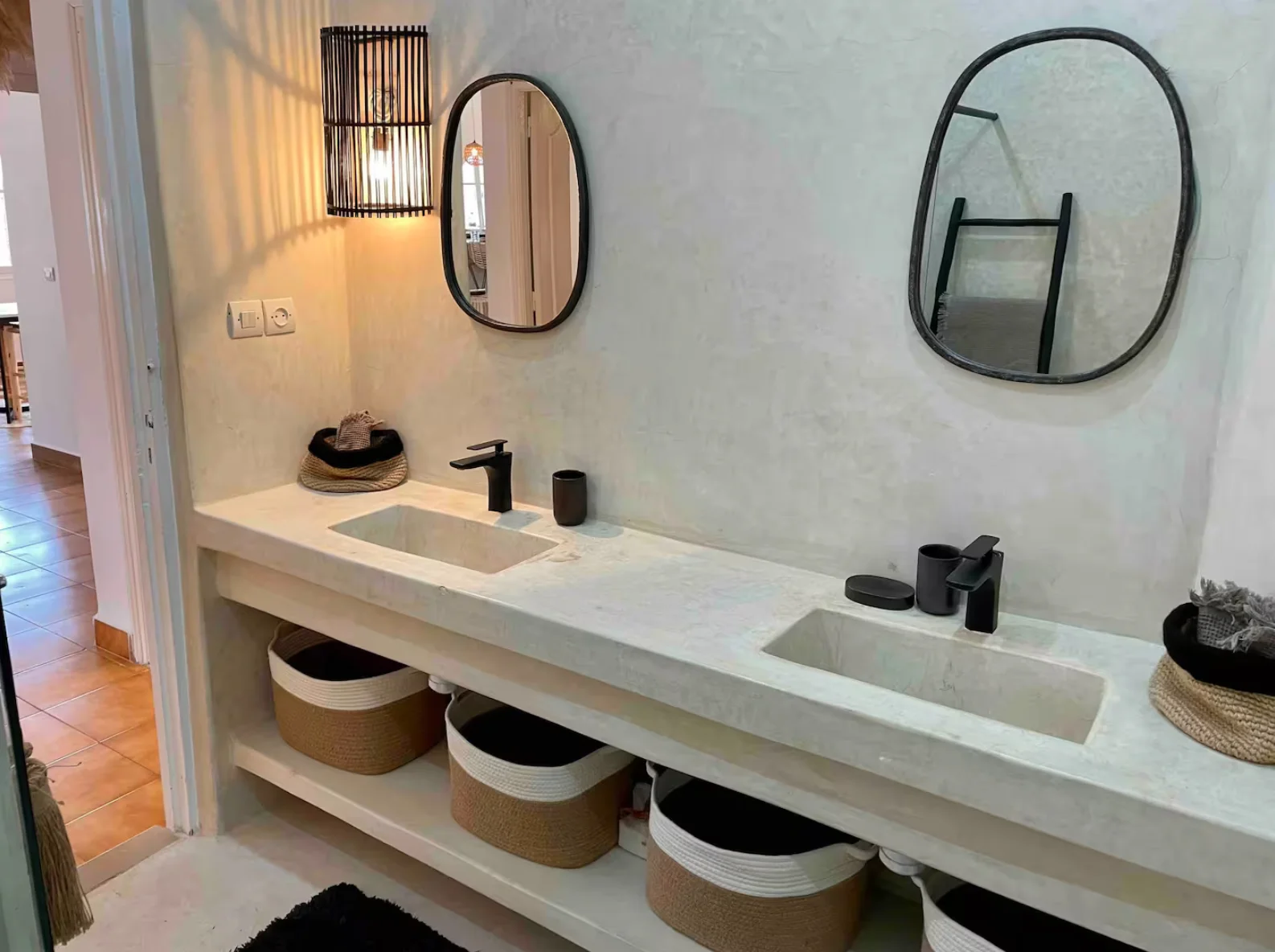 Travertine double sinks with shutter lantern and matte black taps