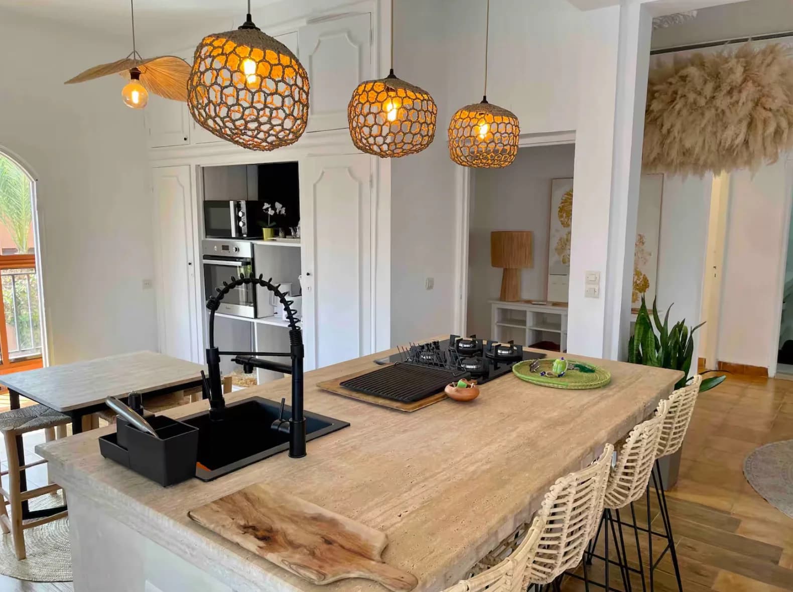 Live-edge wood island with cluster of honeycomb pendant lights