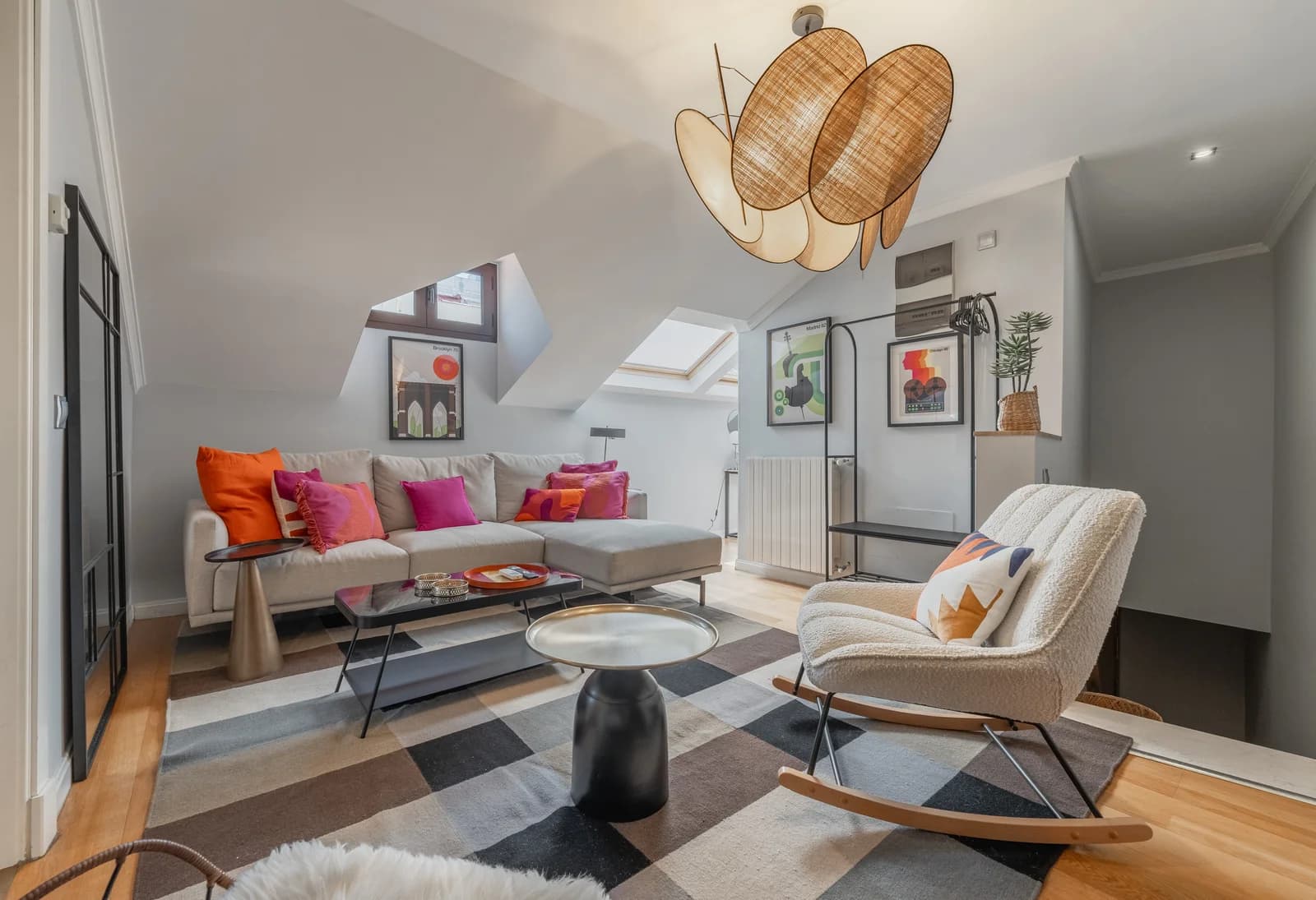 Open lounge with pendant cluster, rocker and herringbone floors