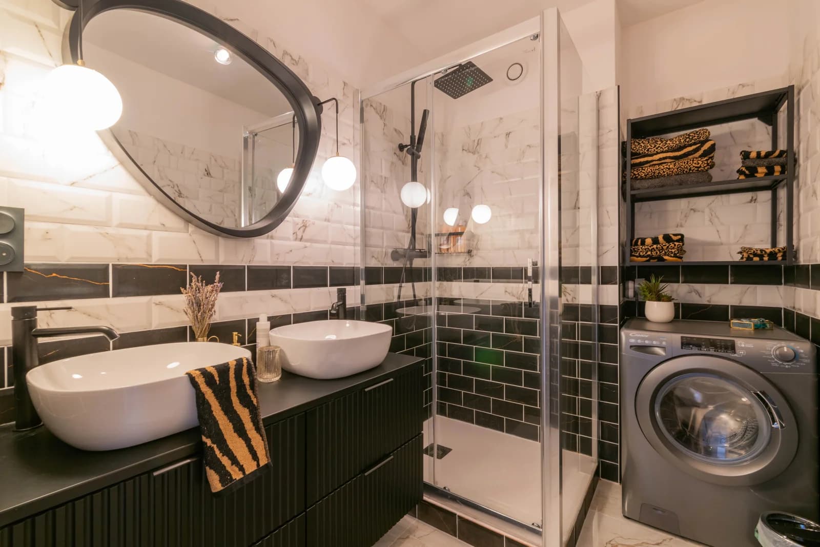 Marble and emerald-tile bathroom with twin basins and walk-in shower