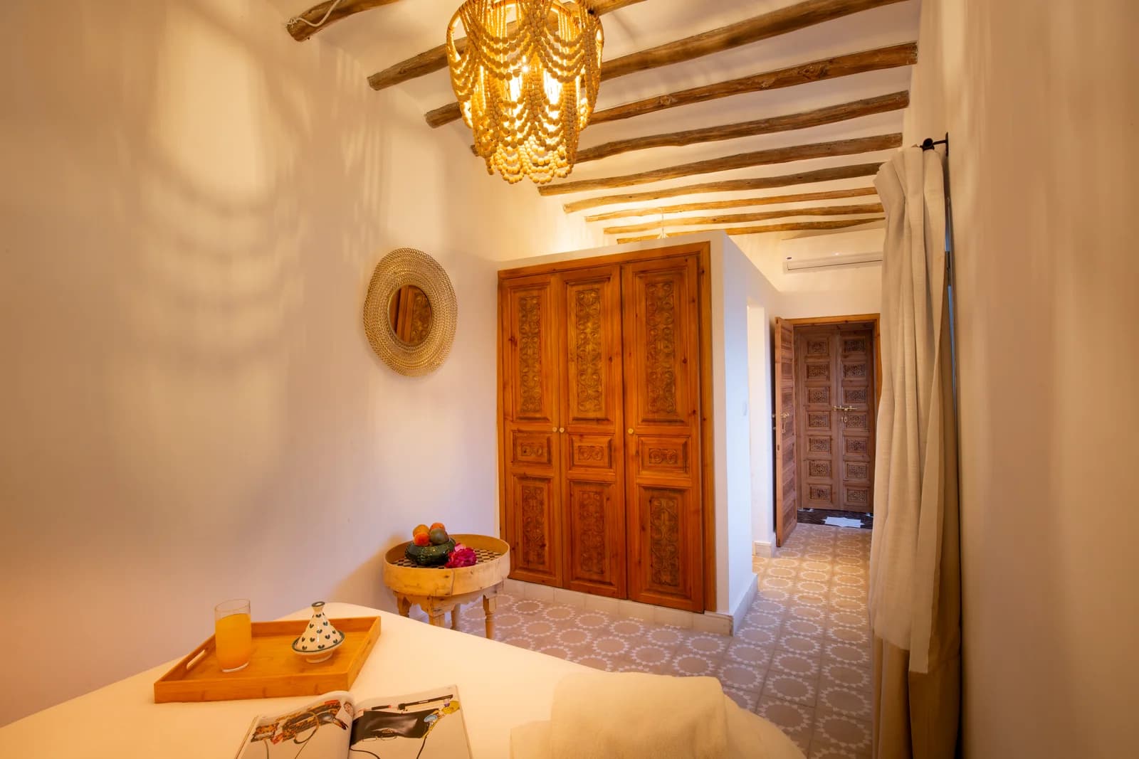 Ensuite suite with beamed ceiling, carved wardrobes and patterned tile
