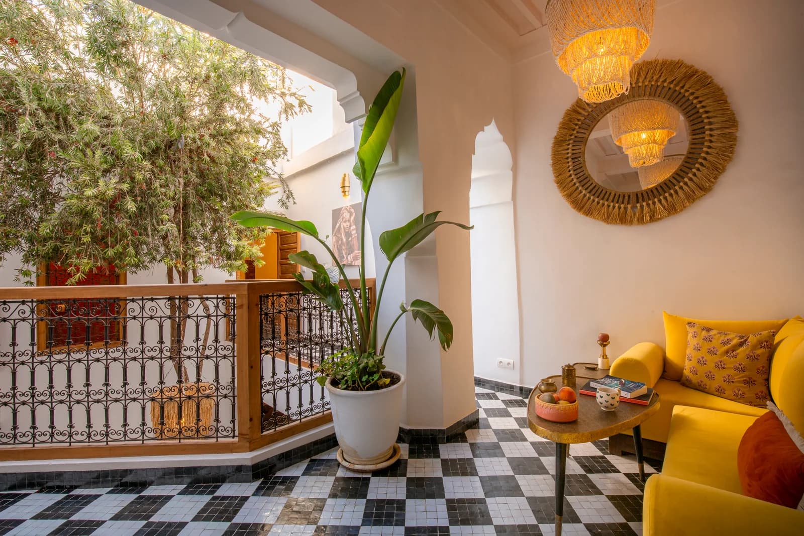 Yellow Moroccan sofa beside checkered tile balcony overlooking patio