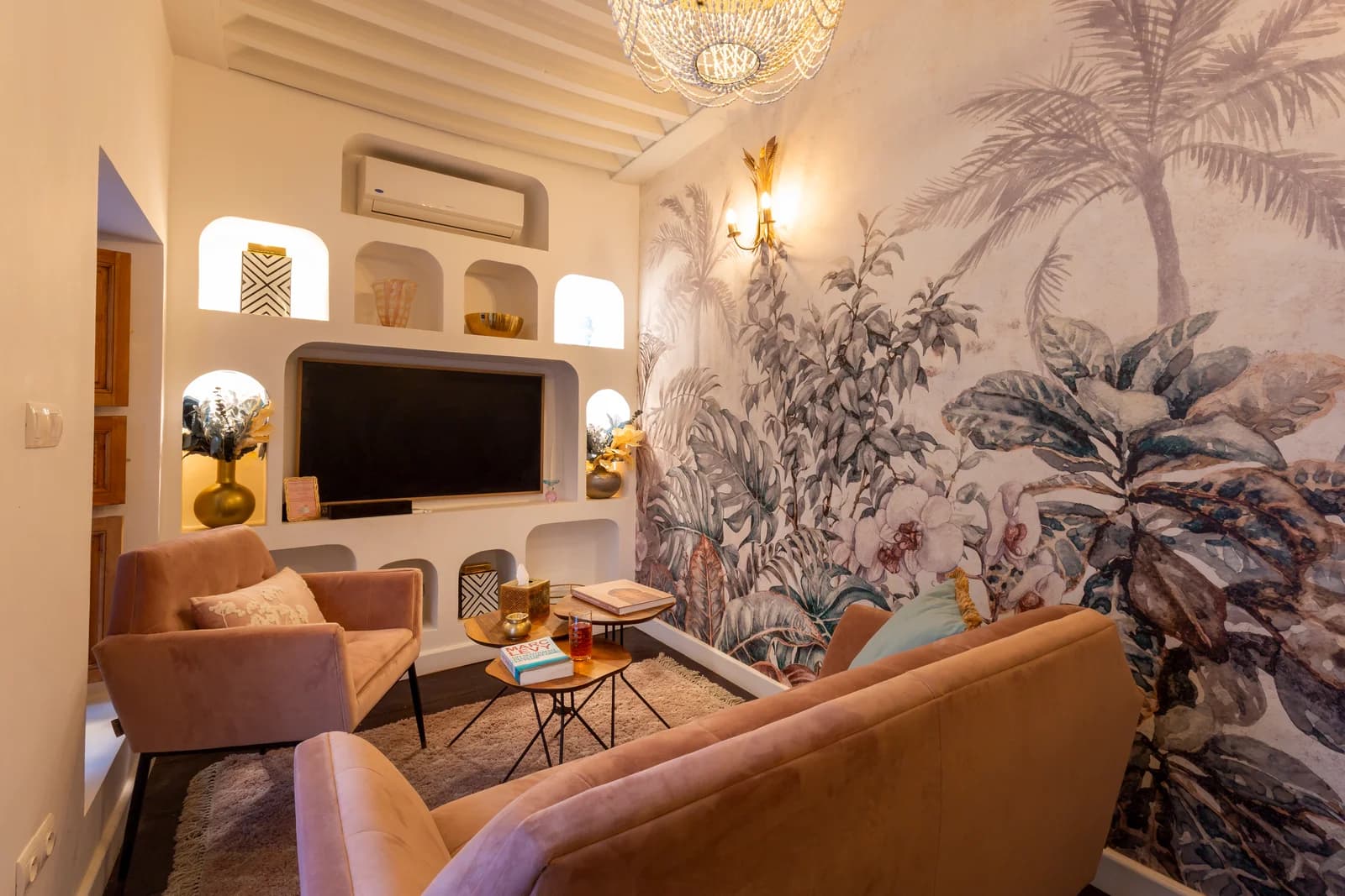 Media lounge with arched niches and lush palm wall mural