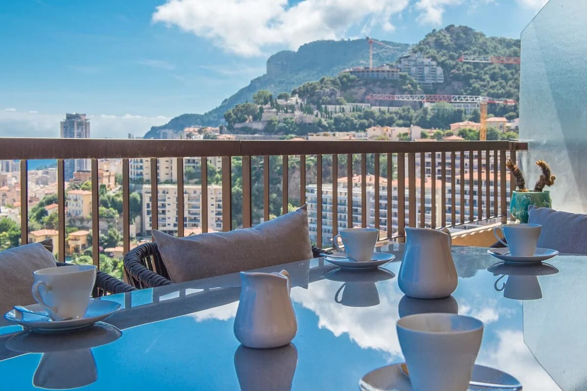Coffee service on terrace with panoramic Monaco mountain backdrop