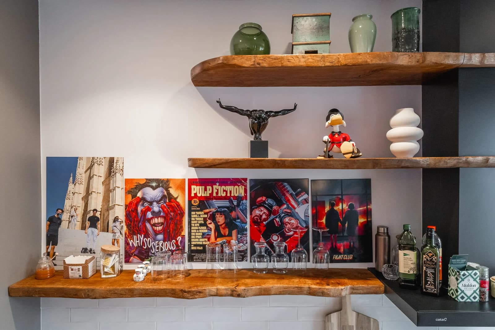 Bar shelf with cult-film posters, glassware and curiosities