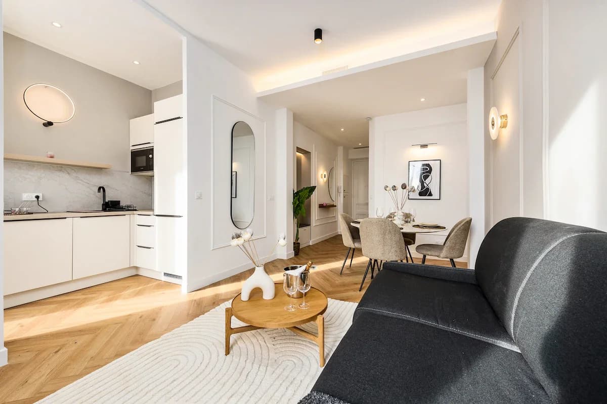 Open living-dining-kitchen in Haussmannian style with herringbone floors