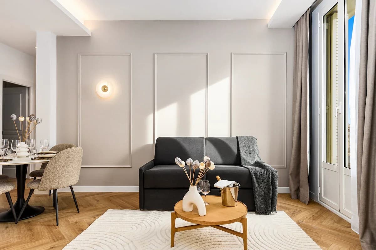 Sunlit lounge with French doors, panel walls and herringbone floor