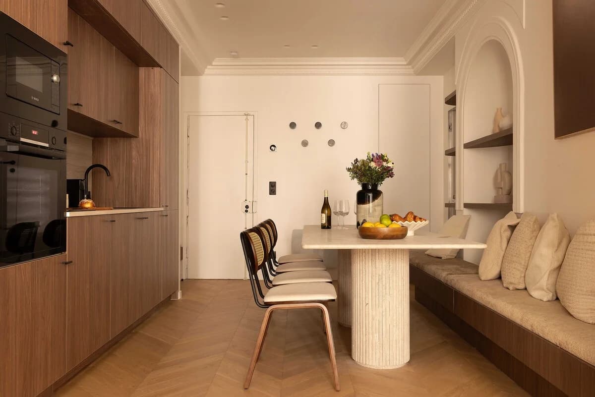 Kitchen-dining nook with banquette seating and arched display niche