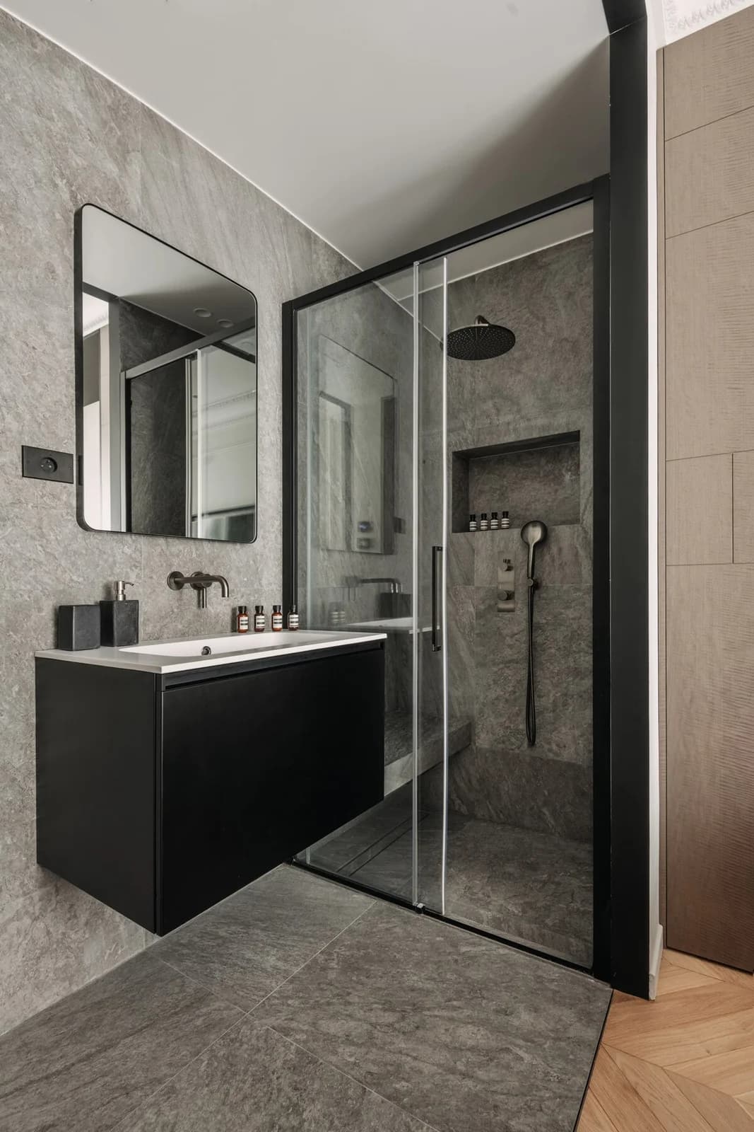 Charcoal stone bathroom with black vanity and glass walk-in shower