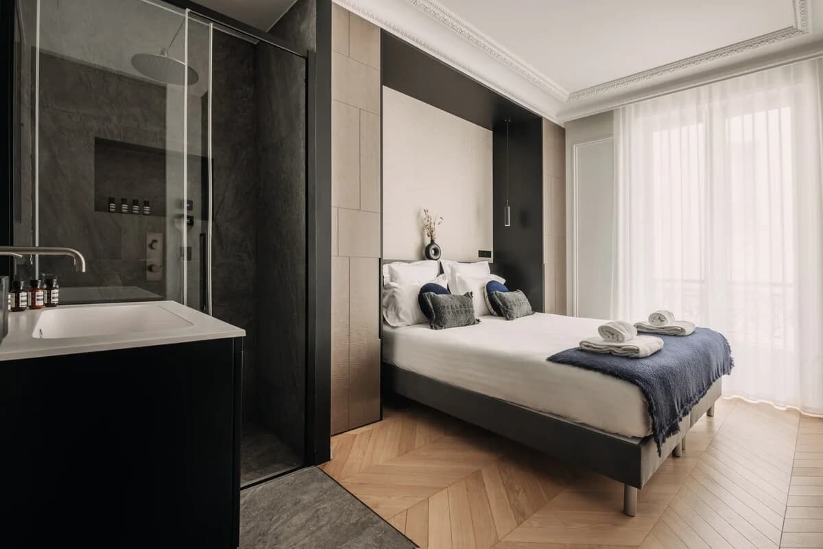 Master bedroom with ensuite glimpse and floor-to-ceiling sheer curtains